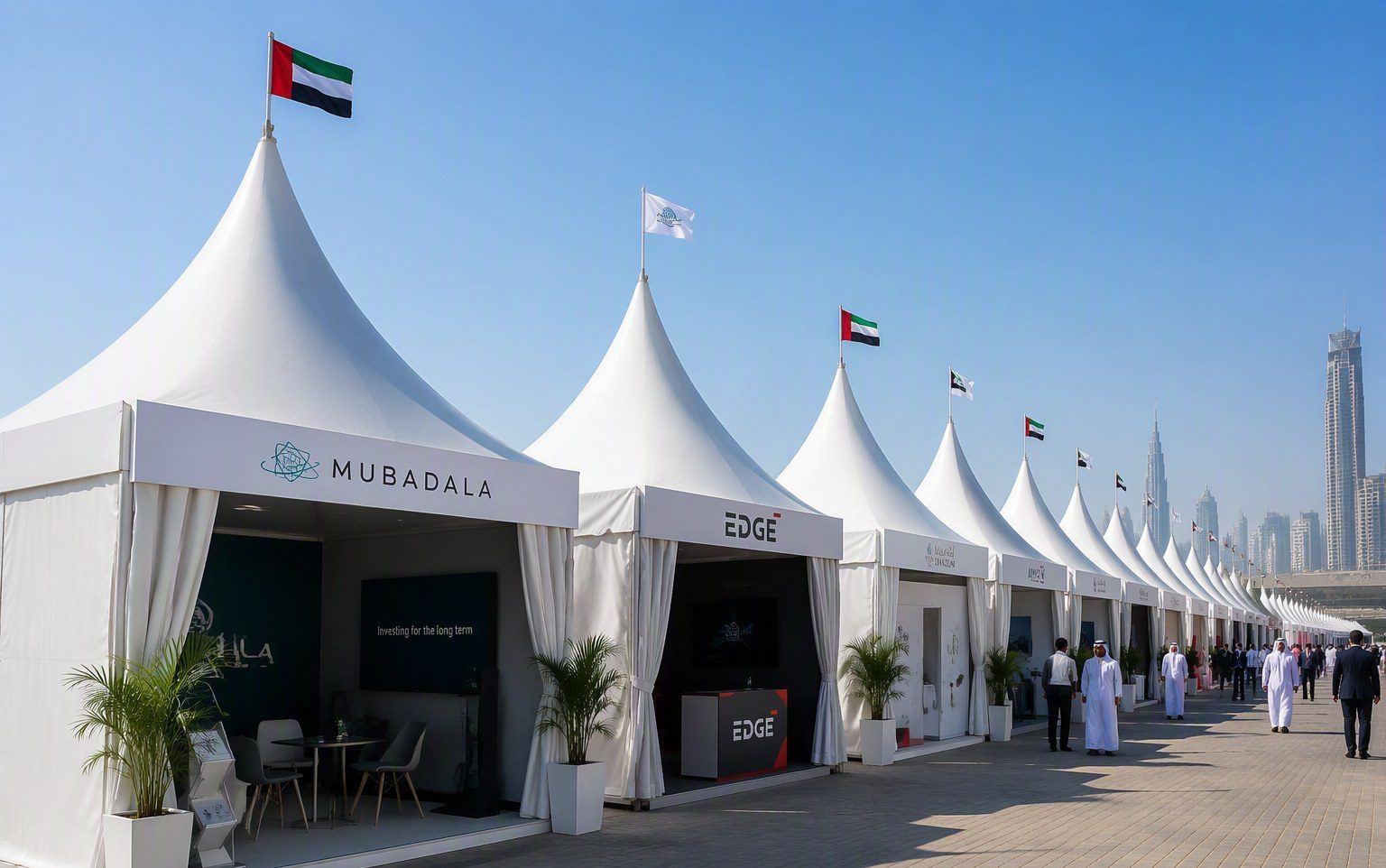 Row of white pagoda tents at an outdoor exhibition in Dubai by Al Hamra Industries