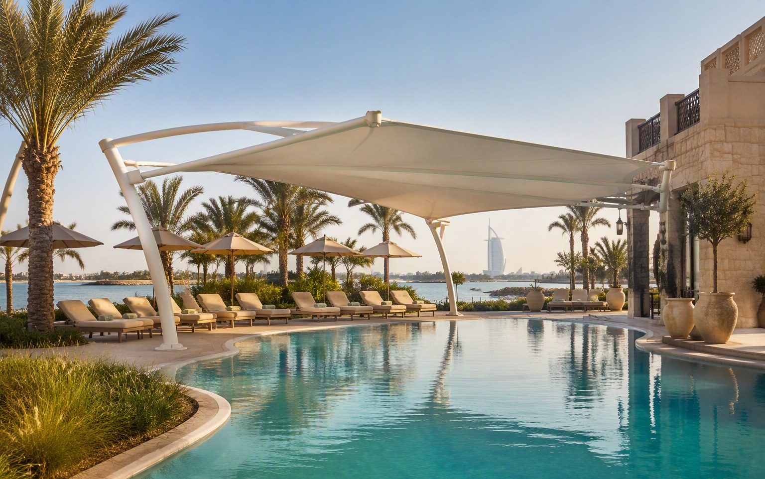 Cantilevered swimming pool shade at a luxury UAE resort installed by Al Hamra Industries