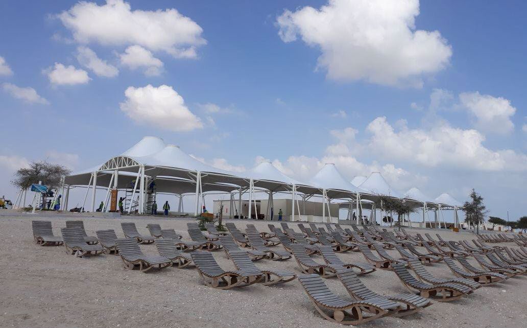 Beach club shade structures and sun loungers at Sir Baniyas island resort