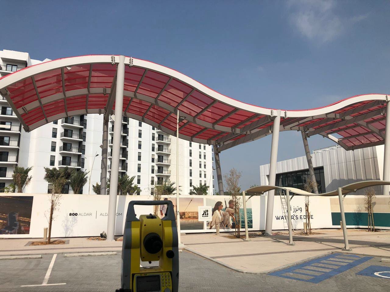 Wave-form red canopies at Water’s Edge Yas Island development