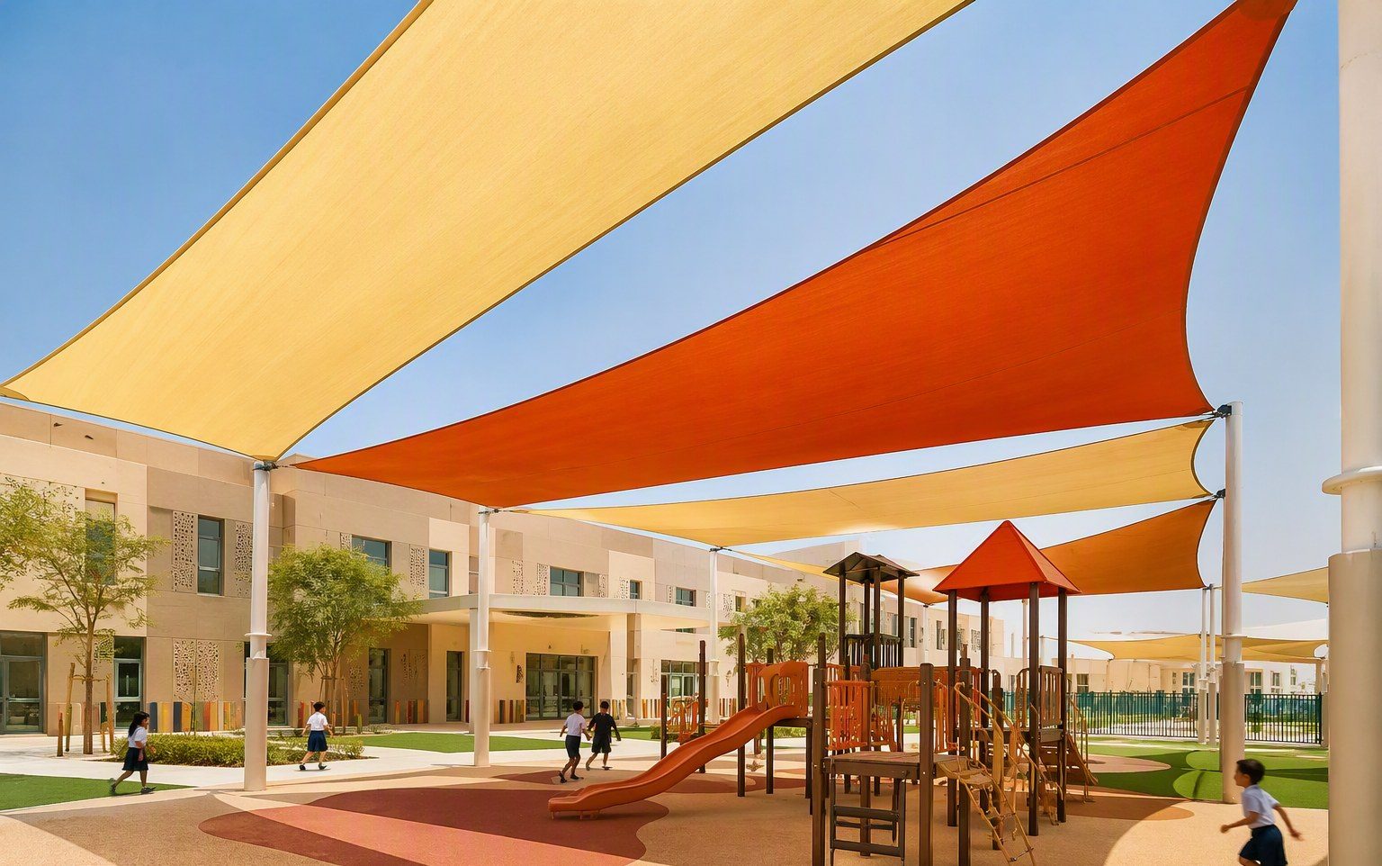 Colourful shade sails over a school playground installed by Al Hamra Industries in the UAE