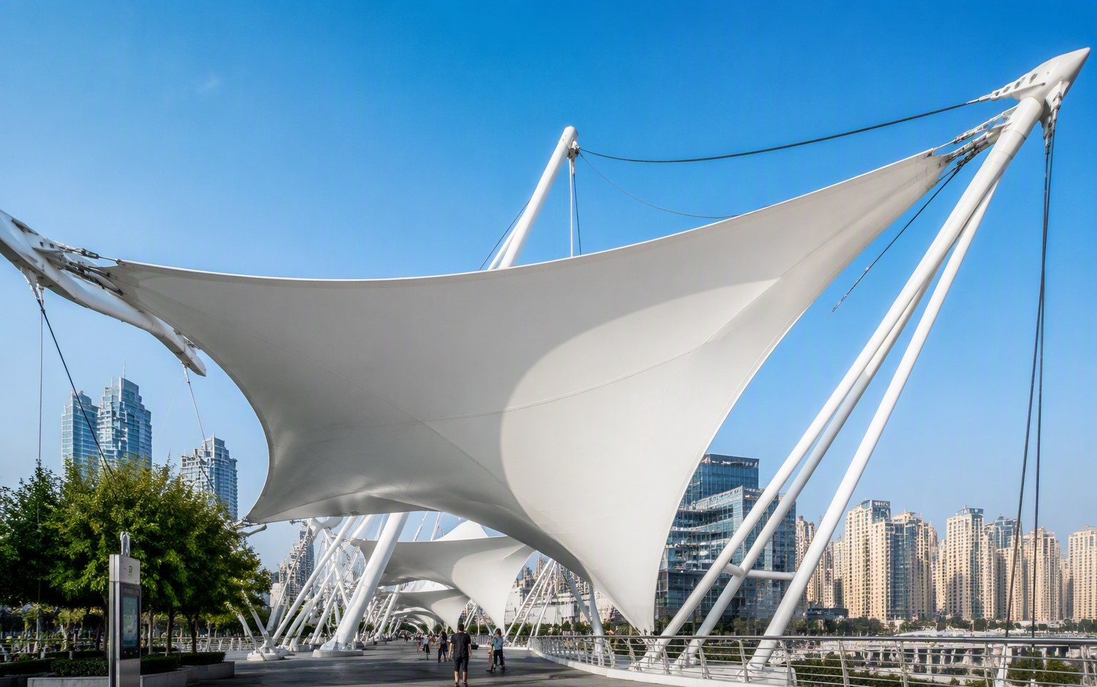 White tensile membrane structure over a public walkway engineered by Al Hamra Industries in Dubai