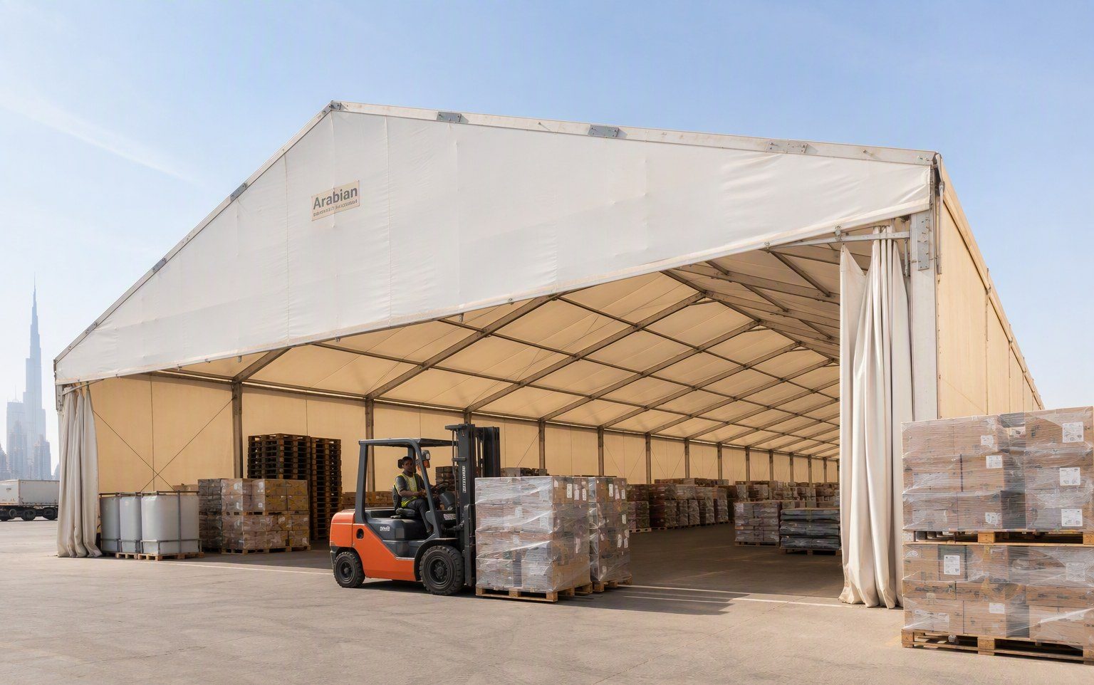 Clear-span warehouse tent with forklift operations in the UAE by Al Hamra Industries